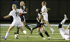 Strongsville midfielder Kelly Novak, 16, recovers the ball after Sylvania Northview defender Ashley Bielski and Strongsville forward Megan Waskowski collide, leaving Waskowski on the ground during the Division I semifinals in Sandusky.