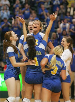 Toledo St. Ursula Academy's Madison Strall, center, leaps into the arms of her teammates after they won the Division I semifinal.