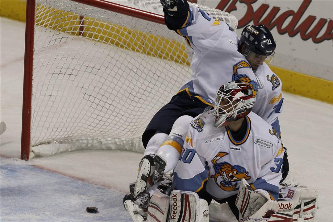 Walleye-Bryan-Rufenach-falls-over-goalie-Carter-Hutton