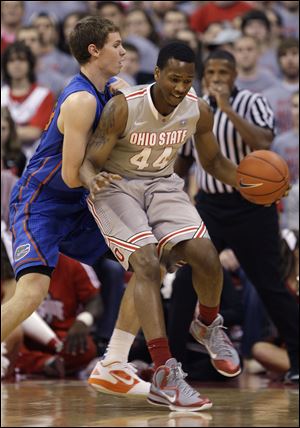 Ohio State's William Buford, right, tries to dribble around Florida's Erik Murphy during the first half of an NCAA college basketball game Tuesday.