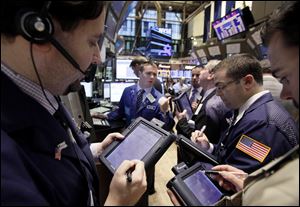 Traders work on the floor of the New York Stock Exchange.