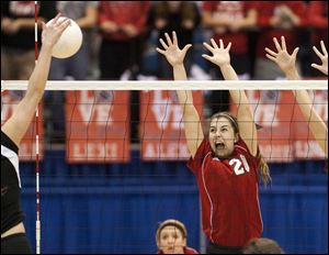 Temperance Bedford's Amanda Swisher leaps up to attempt a block on a Rockford spike.