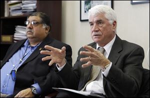 Toledo Public Schools Board of Education president Bob Vasquez, left, and Superintendent Jerome Pecko, right, discuss plans for TPS.