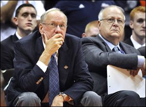 Syracuse basketball coach Jim Boeheim, left, watches the action with Bernie Fine, an assistant coach, during a college basketball game against Manhattan earlier this week in the NIT Season Tip-Off in Syracuse, N.Y. 