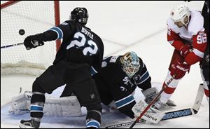 San Jose Sharks' Dan Boyle, left, watches a goal by Detroit Red Wings' Niklas Kronwall, during the first period of an NHL hockey game in San Jose, Calif. At center is Sharks goalie Antti Niemi; and Red Wings' Tomas Homstrom is at right.