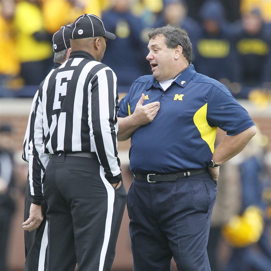 UM-head-coach-Brady-Hoke-speaks-with-officials