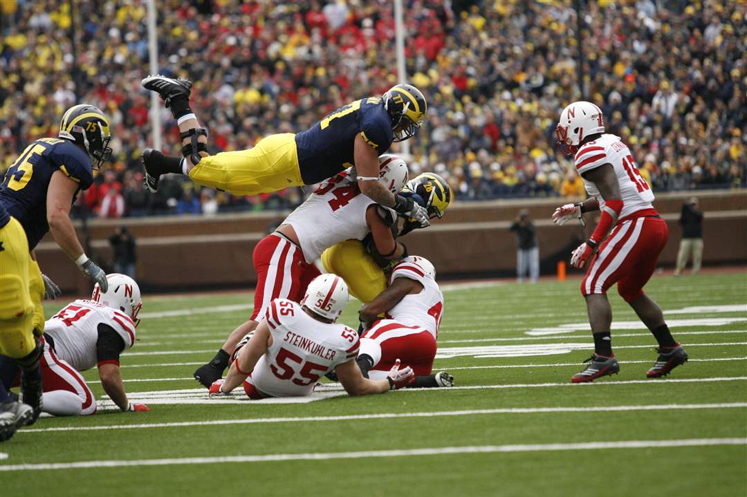 A-Michigan-player-goes-airborne-on-Saturday-at-the-Big-House-in-Ann-Arbor
