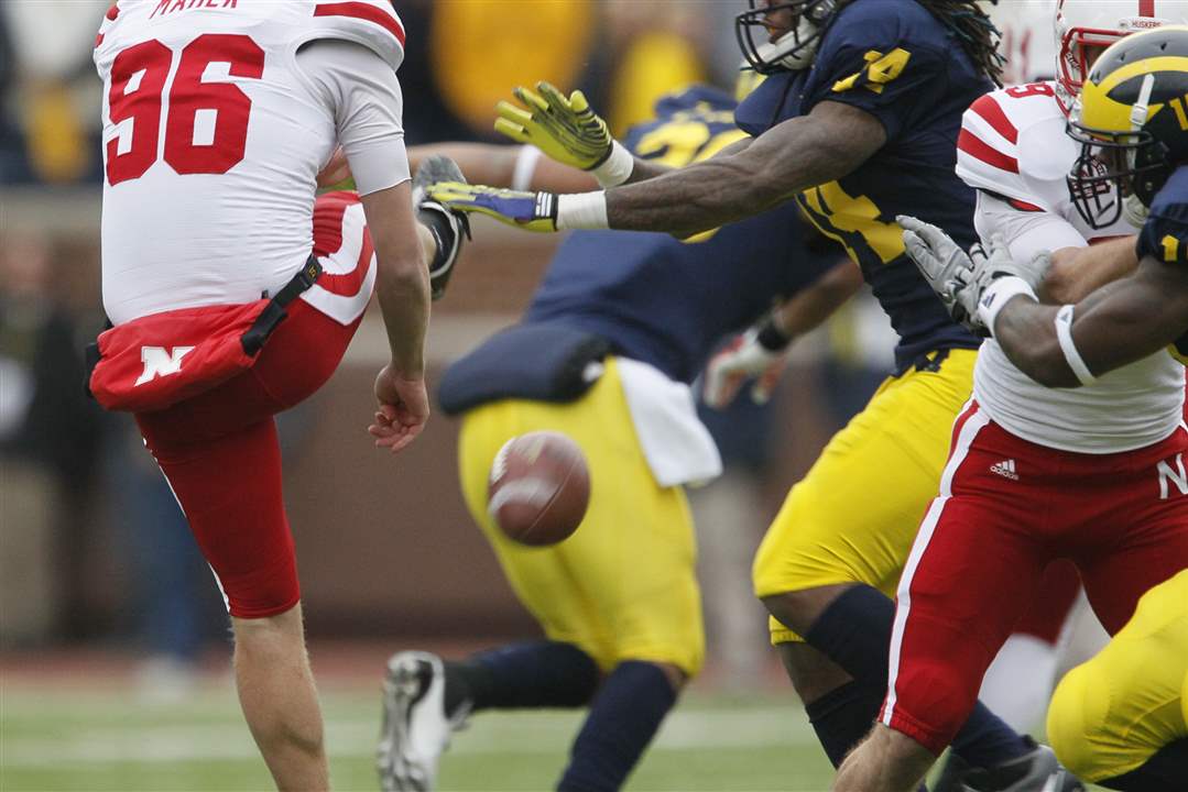 UM-s-Josh-Furman-14-blocks-the-punt-of-Nebraska-punter-Brett-Maher