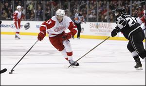 Detroit Red Wings center Pavel Datsyuk, left, stretches for the puck ahead of Los Angeles Kings defenseman Slava Voynov (26) in the third period of an NHL hockey game in Los Angeles on Saturday.