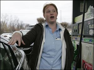 Sara Rafac of Sylvania Township fills her car in Sylvania. The average price for a gallon of gas is up over last year at this time, but that doesn't matter to Ms. Rafac. She still plans to travel over the Thanksgiving holiday to visit brothers who live in suburban Chicago.   
