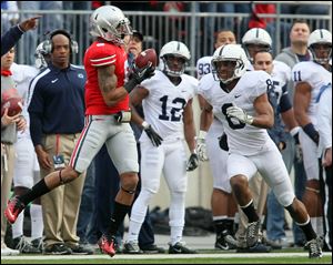 Ohio State wide receiver DeVier Posey, who had been suspended for 10 games, makes a catch for a first down against Penn State's D'Anton Lynn in the first quarter. Posey made four catches for 66 yards.