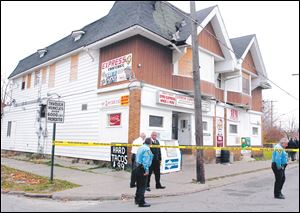 Toledo police secure the area in front of the Express Carryout, 1920 Mulberry St. Lamar Allen of Toledo was shot and killed Monday morning. A second man fled the scene.