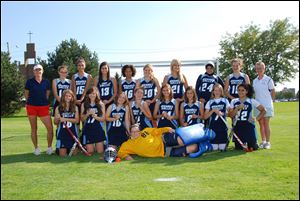 Team members gather behind goal tender Kelsie Snyder. Kneeling, from left, are Sarah Nathan, Cammie Lonsway, Lauren Kohler, Katie Meyer, Audrey White, Sarah Reddy, Alicia Underwood, and Ranim Maaieh. Standing, from left, are coach Terri Herrmann, players Emily Boyk, Sukanya Dayal, Madeline Abdoo, Kayla Turner, Delaney Lonsway, Genna Danes, Amal Mohammed, and Kaylou Stoddard, and coach Paula Prediger. Not pictured are Delia Safadi and Ashley Taylor. This year's team matched the longest postseason run in the school field-hockey program's history.