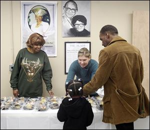 Doris Jones, left, and Paige O'Loughlin hand out desserts at the soup kitchen, which started serving meals in 1969. This was the first Thanksgiving at the kitchen since the death of longtime leader Juanita Savage Person.