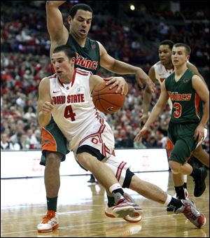 Ohio State's Aaron Craft (4) drives to the basket past Texas-Pan American's Ruben Cabrera (13) during the second half of an NCAA college basketball game Saturday in Columbus.