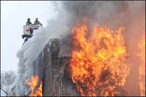 Toledo firefighters battle a blaze in a vacant building at 2125 Dorr St., the second here in less than two weeks. Fire Lt. Matthew Hertzfeld said the building caught fire about 8 a.m. Friday and was left to burn. Fire crews did enter the building to try to save it, but damage from the first fire made it unsafe, the lieutenant said. Crews set up a perimeter around the building to make sure the fire did not spread and conducted a controlled burn. Despite no official ruling, because the building was vacant, it is being investigated as an arson. No injuries were reported, and the building was razed. The building dated to 1924 and was owned by Timothy Wyse of Woodland Avenue, according to Lucas County auditor’s records.