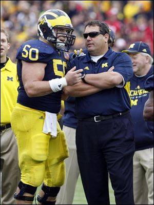 Michigan offensive lineman David Molk (50)  is a finalist for the Rimington Award while Wolverines coach Brady Hoke is a finalist for the Coach of the Year Award.