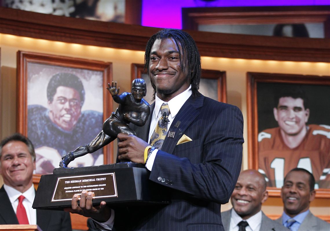 Robert Griffin III, of Baylor University, holds the Heisman Trophy award after being named the winner, Saturday.