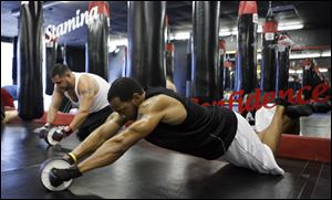 Will Gordon works out with an ab wheel at Extreme Results by Vince. Experts say start-ups with the right formula can flourish, and existing businesses are finding that taking a chance in a down economy can yield terrific results.