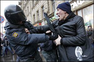 A St. Petersburg police officer clashes with a protester angry over the results of the parliamentary elections in Russia. Demonstrations occurred across the country, with thousands fed up with the rule of Prime Minister Vladimir Putin.