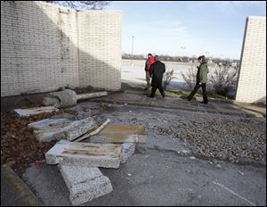 A portion of an exterior wall is in pieces. Northwood city and fire officials inspected the Woodville Mall in Northwood.