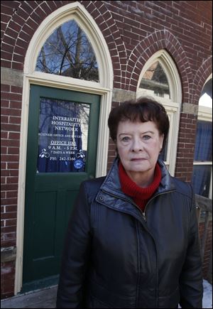 Paula Lewis, former executive director of the Interfaith Hospitality Network, also known as Family Promises, poses outside the homeless shelter on Western Ave. in South Toledo.  The shelter has closed due to lack of funding.