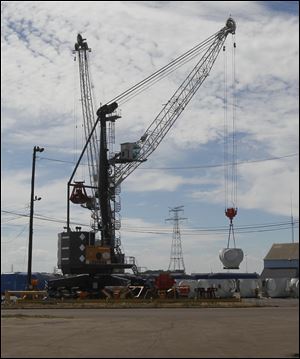 Mobile cranes Muddy, left, and Spike are among improvements at the port of Toledo in a recent $25 million modernization program that includes a materials handler and a dry-bulk conveyor. The new machines are more efficient and of higher capacity than their predecessors.