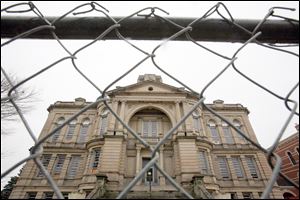 A chain-link fence surrounds the courthouse, placed there Monday in preparation for demolition.
