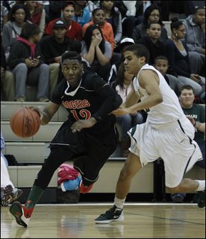 Rogers' Clemmye Owens gets around Start's Sam Young. Owens finished with 18 points.