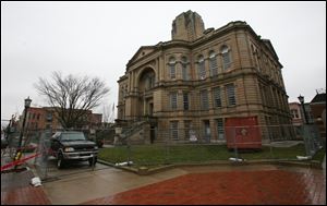 The Seneca County Courthouse sits silent as workmen busily labor inside this week, removing asbestos before demolition can begin.
