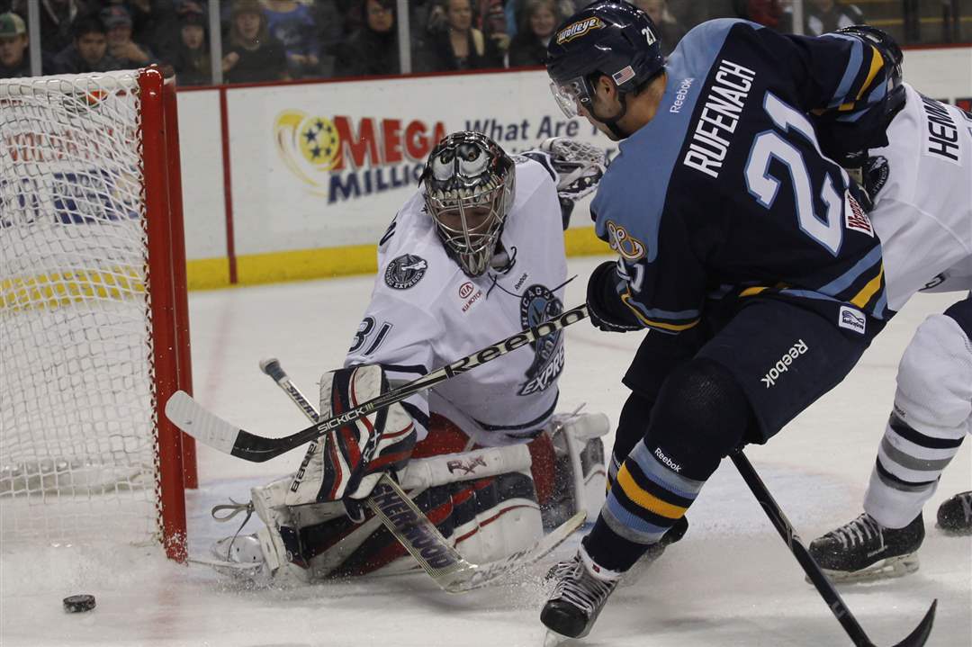 Chicago-goalie-Paul-Dainton-blocks-a-shot-by-Walleye-s-Bryan-Rufenach