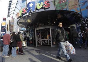 A last-minute shopper leaves the Toys R Us store in New York. In the week before Christmas, shoppers gave retailers a 4.5 percent hike in revenue over the same week last year at stores open at least a year.