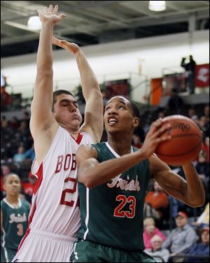 Central Catholic's Danielle Turner looks to take a shot while being guarded by Bowling Green's Andrew Herringshaw. Turner had 15 points for the Irish, including a key jumper to break a scoring drought.