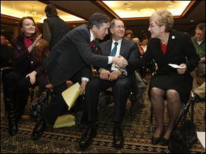 U.S. Congressmen Dennis Kuchinich, left, and Marcy Kaptur shake hands as they greet each other at the Nuclear Regulatory Commission public meeting at Camp Perry in Port Clinton, Thursday. 