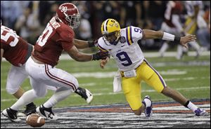 LSU's Jordan Jefferson fumbles as he is hit by Alabama's Dont'a Hightower (30) during the second half of the BCS National Championship college football game.