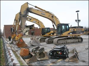 Construction equipment sits in front of Libbey High School as demolition of the building begins.