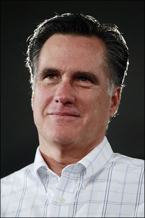 Republican presidential candidate, former Massachusetts Gov. Mitt Romney, listens as he is introduced at a campaign event at the Boys and Girls Club in Salem, N.H., Thursday, Jan. 5, 2012. (AP Photo/Charles Dharapak)