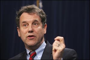 Restructuring helped stabilize Chrysler and GM, U.S. Sen. Sherrod Brown says during a stop at UAW Local 12 in Toledo.