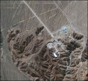 In this Sept. 26, 2009 file satellite image provided by GeoEye shows a facility under construction inside a mountain located about 20 miles (32 kilometers) north northeast of Qom, Iran. Iran has begun uranium enrichment at a new underground site well protected from possible airstrikes, a leading hardline newspaper reported Sunday, Jan. 8, 2011.