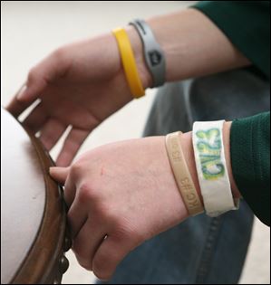Clay hockey player AJ Burns wears a bracelet in memory of Cody Van Hersett. Most of Cody's teammates were upperclassmen, but they adopted Cody as one of their own. The basement at Cody's house was the place where the team liked to hang out. 