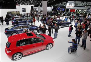 Car fans check out vehicles at the North American International Auto Show in Detroit, Mich.