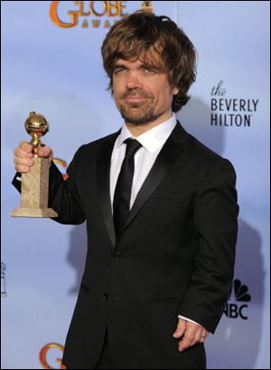 Actor Peter Dinklage poses backstage with the award for Best Supporting Actor in a Series, Mini Series or TV Movie for 