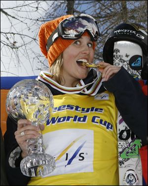 Sarah Burke, of Canada, celebrates on the podium after winning the women's halfpipe freestyle title at the 2008 World Cup finals in Valmalenco, Italy.