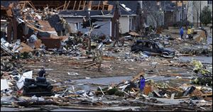 Residents walk around through the debris of their neighborhood after a possible tornado ripped through the Trussville, Ala., area. Jefferson County sheriff's spokesman Randy Christian said the storm produced a possible tornado that moved across northern Jefferson County around 3:30 a.m., causing damage in Oak Grove, Graysville, Fultondale, Center Point, Clay and Trussville.   