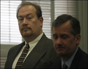 CTY principal24p   William Buzzell, left, with attorney Jeff Helmick, appears Monday in Wood County Common Pleas Court in Bowling Green.