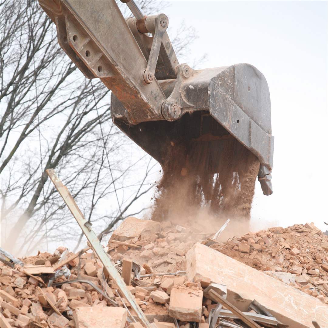 backhoe-dumps-debris