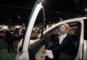 Marianne Ballas, chairman of the charity preview gala for the Toledo Auto Show at the SeaGate Convention Centre, steps out of a GMC sport utility vehicle during the party. Proceeds from the gala, put on by the Toledo Auto Dealers Association, go to five local charities.