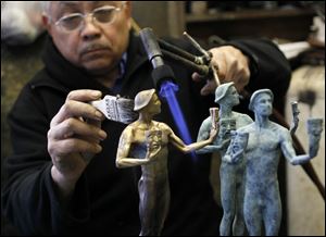 Artist Joaquin Quintero applies patina finish treatment to Screen Actors Guild Award 