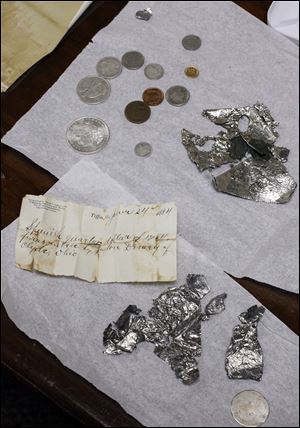 Items from the time capsule unearthed at the Seneca County Courthouse are set on a table at the Seneca County Museum.