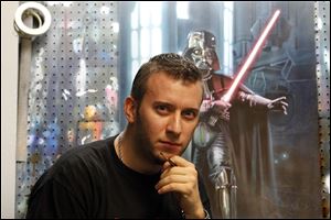 Local artist Brian Rood, seen here in his home studio in Temperance, Mich., is a freelance artist contracted by various licensing companies to paint Star Wars and other merchandising images.